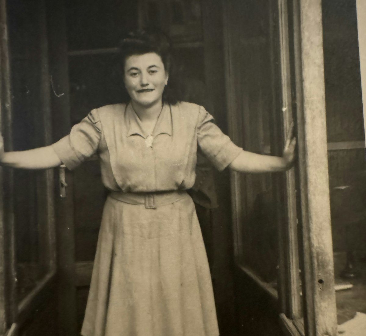 Donna's mother, Magdalena standing outside a storefront. 
