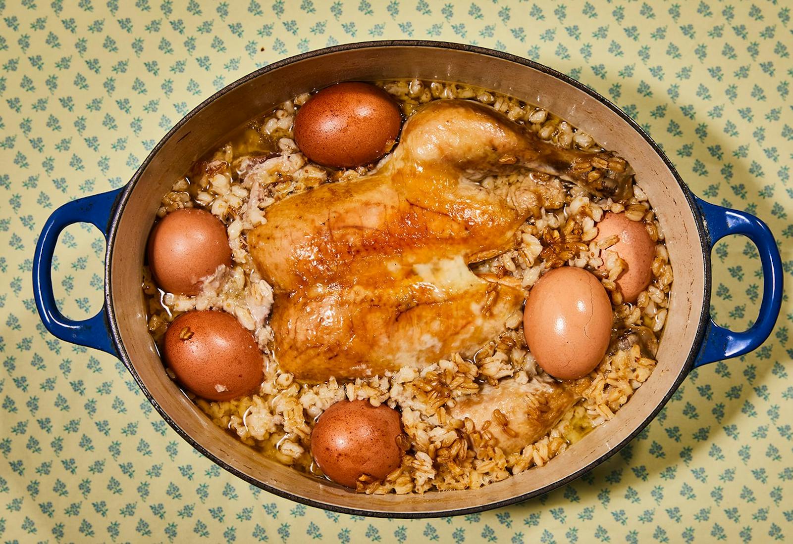 Harissa in blue dutch oven atop yellow and blue tablecloth.