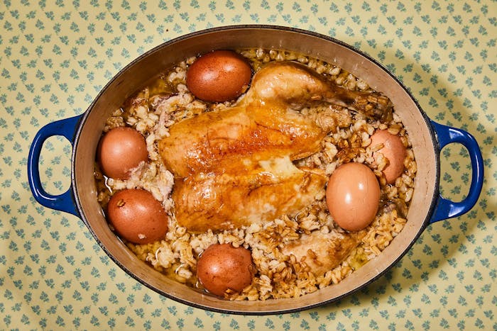 Harissa in blue dutch oven atop yellow and blue tablecloth.