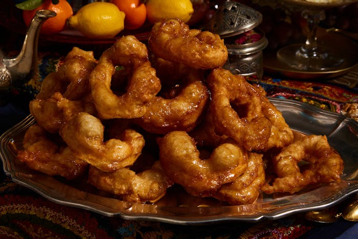 Moroccan sfenj piled atop metal platter.