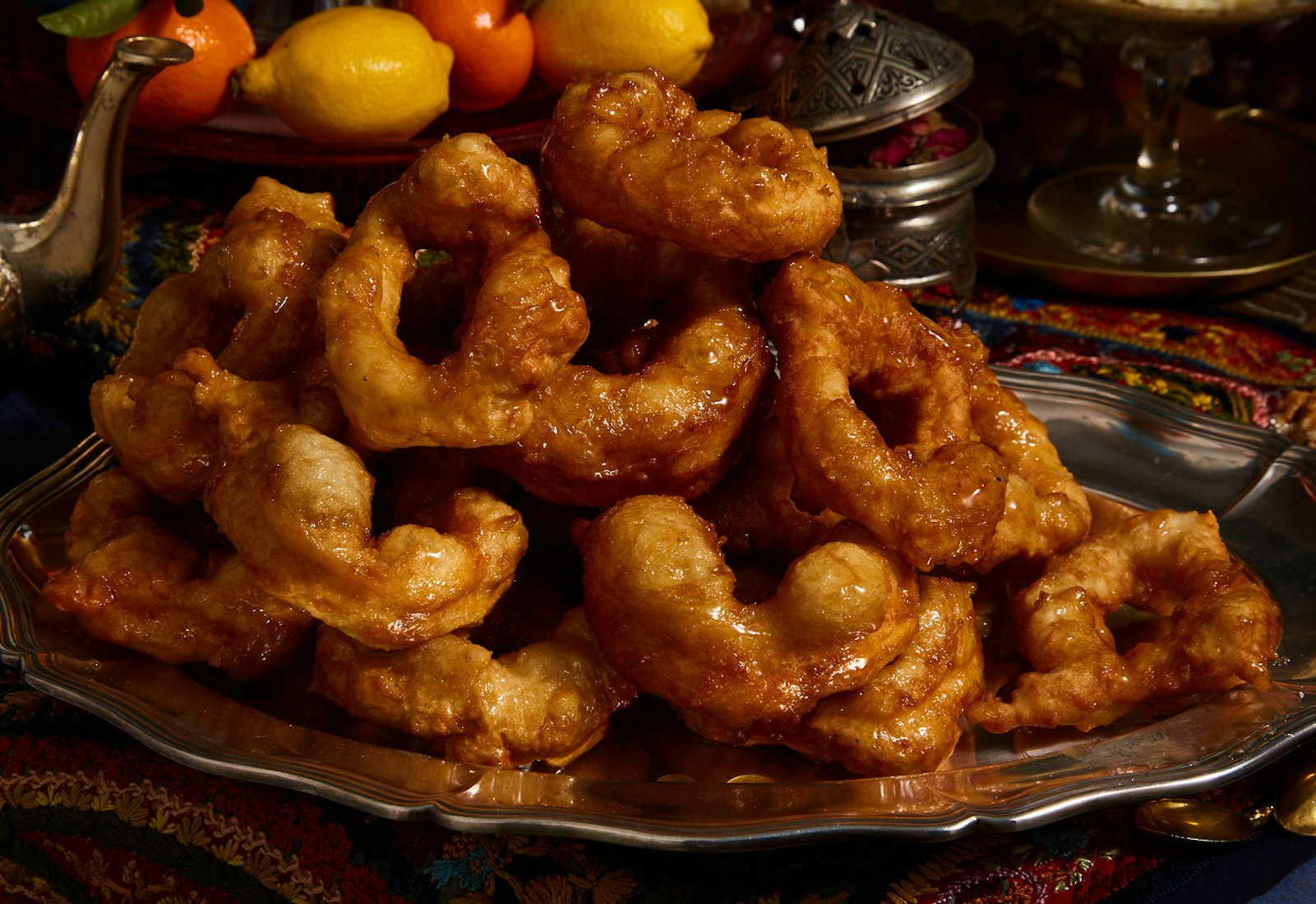 Moroccan sfenj piled atop metal platter.