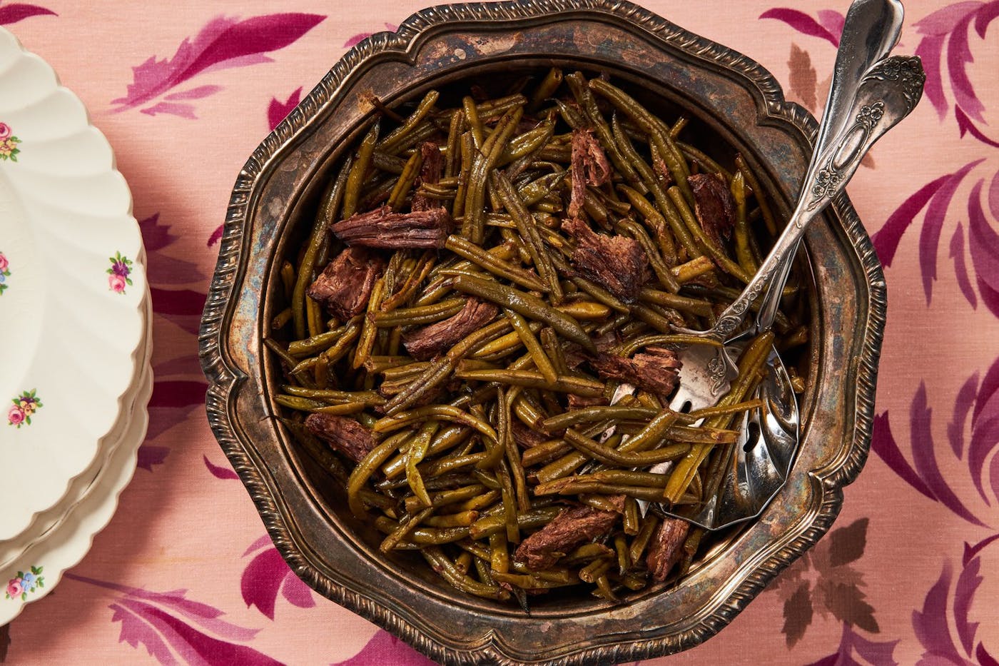 Faulle in large serving bowl, floral plates atop pink tablecloth.