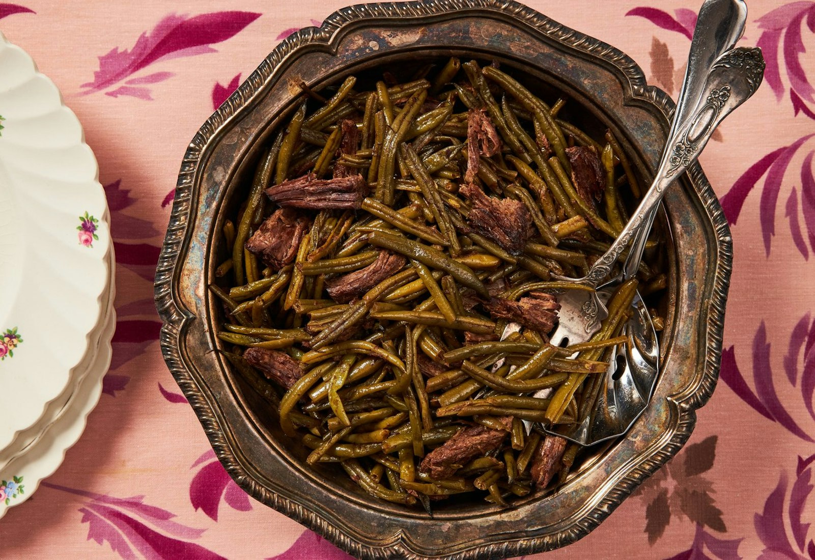 Faulle in large serving bowl, floral plates atop pink tablecloth.