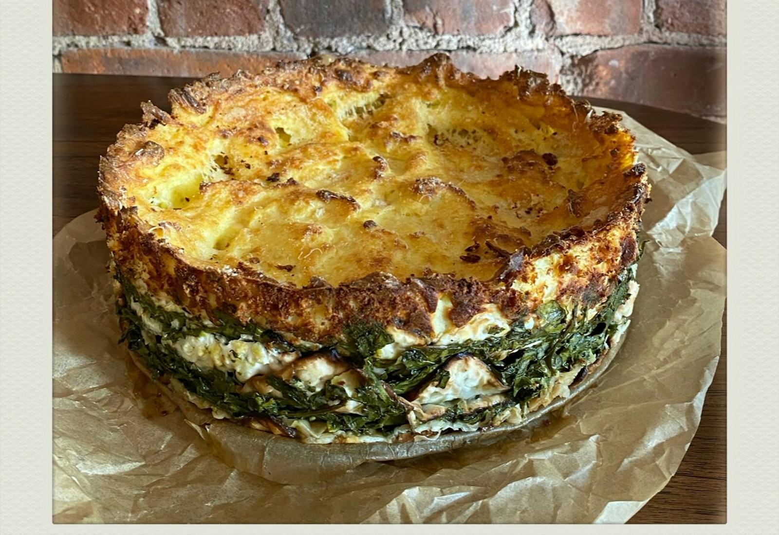 Mina on parchment paper atop wooden table, in front of brick wall.