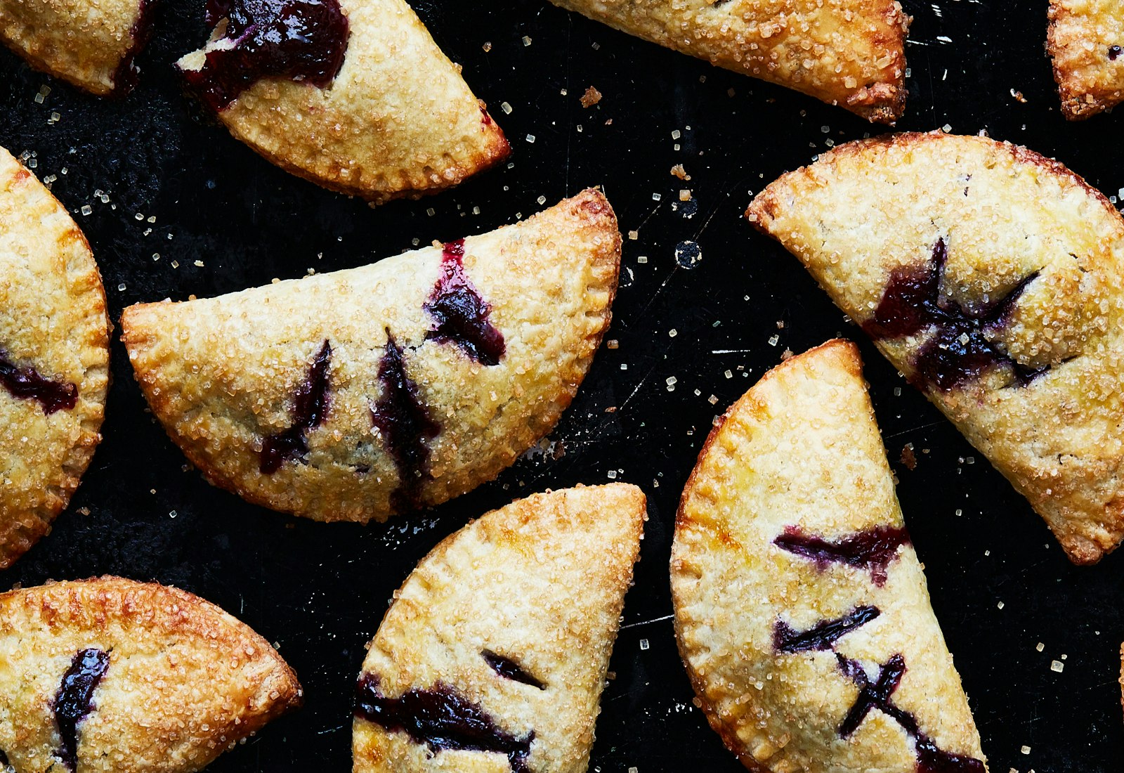 Blueberry stonekes on black surface.