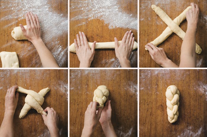 Chef braiding challah atop floured wooden surface.