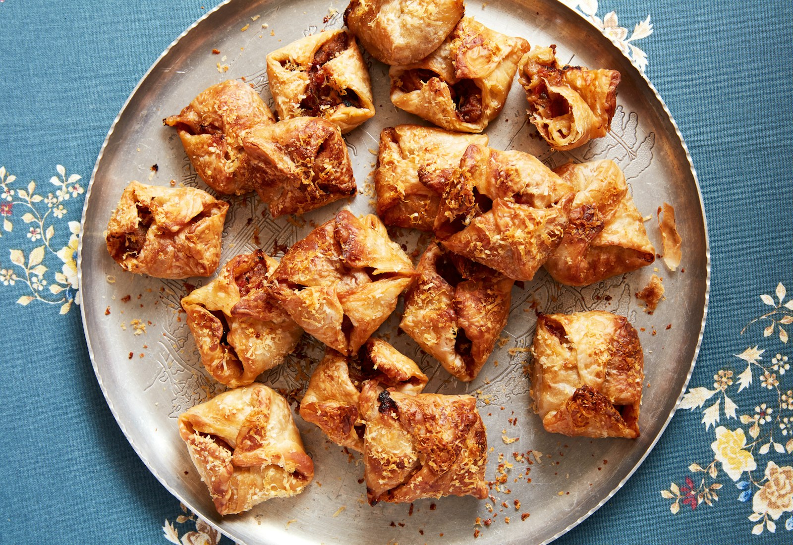 Boyos on silver metal plate atop blue tablecloth.