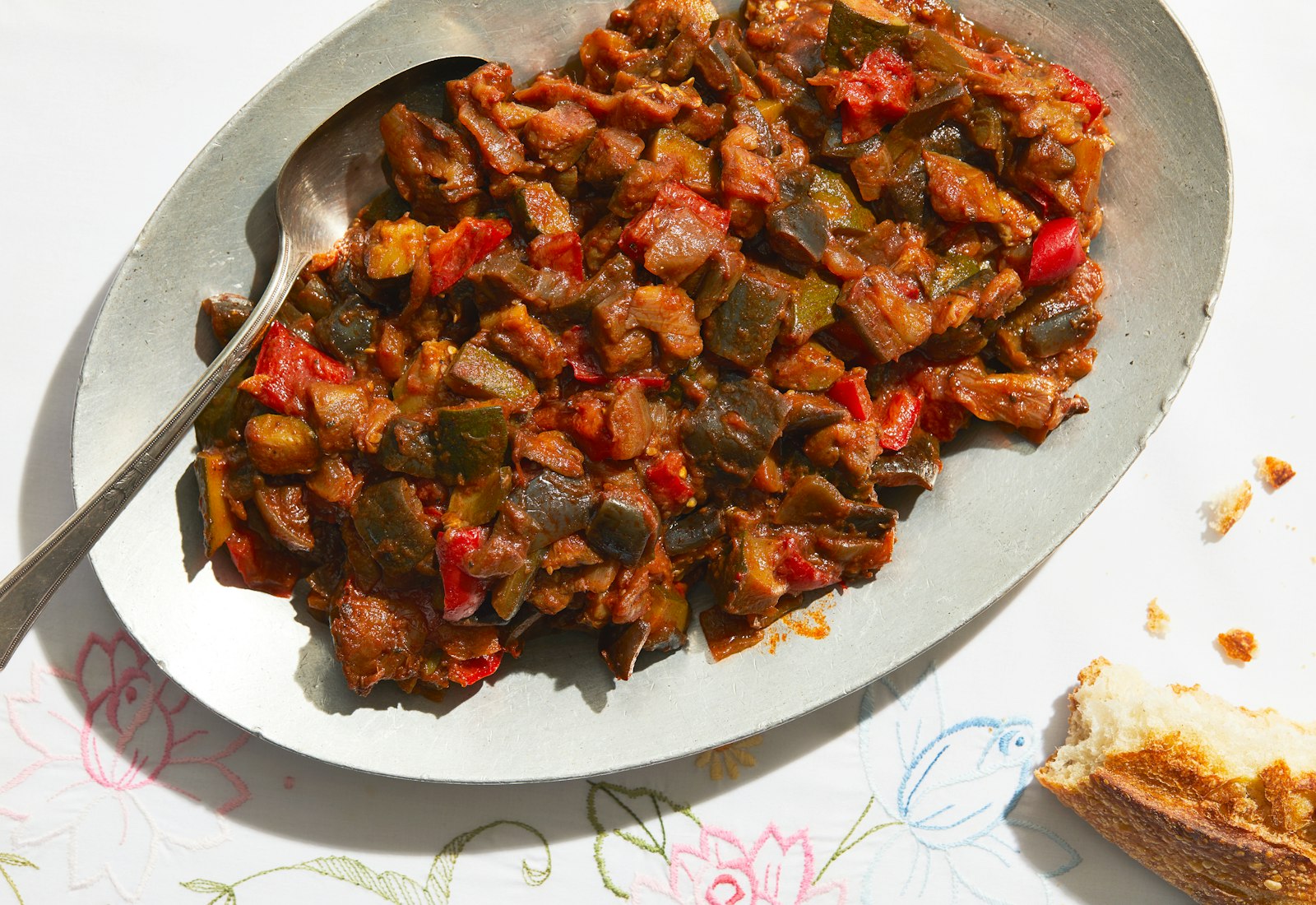 Kamfounata on light grey, oval serving platter with serving spoon.