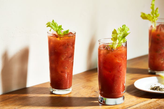 Two tall glasses of bloody miriam with celery