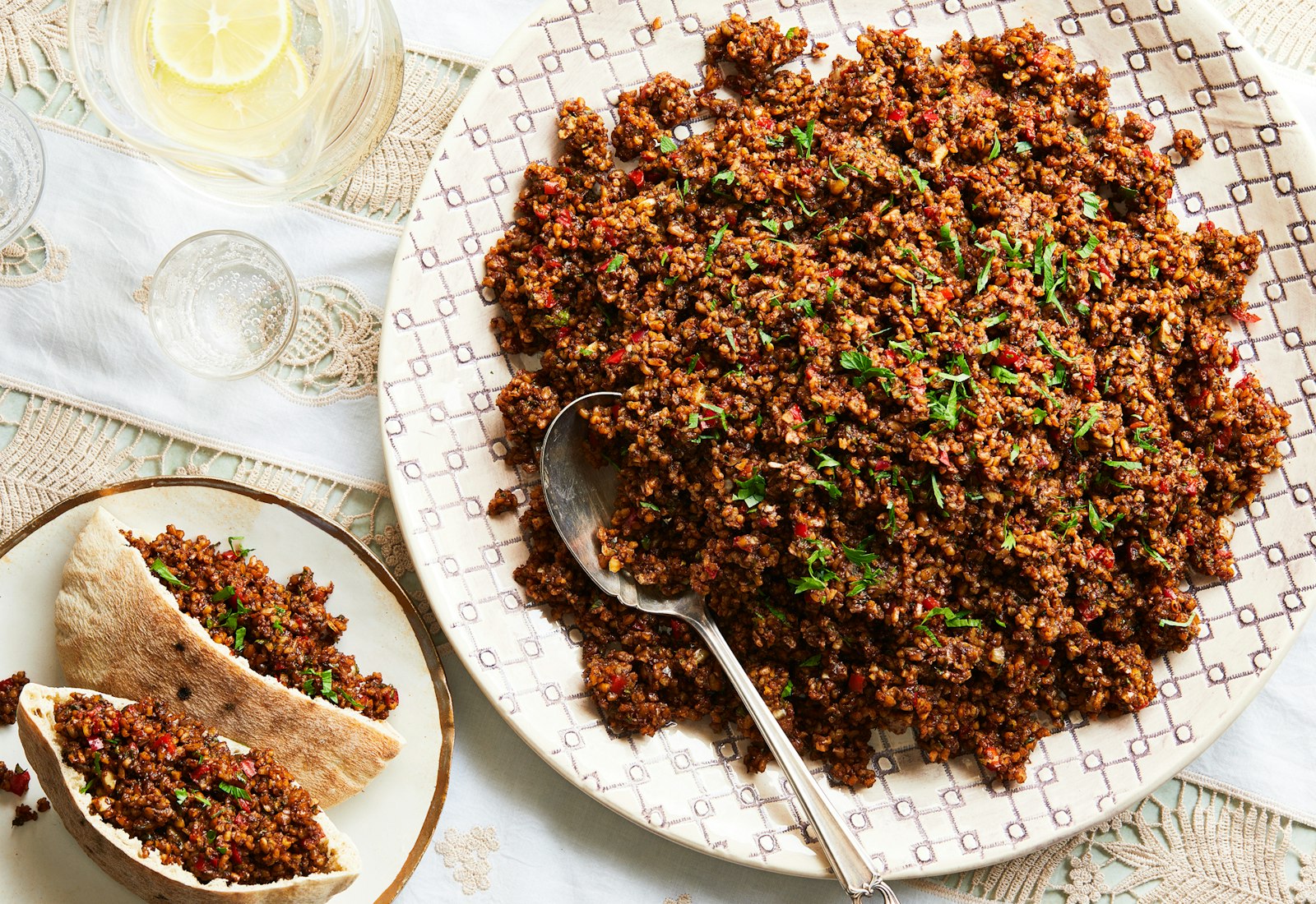 Bulgur and tamarind salad in a large bowl with pita on the side. 