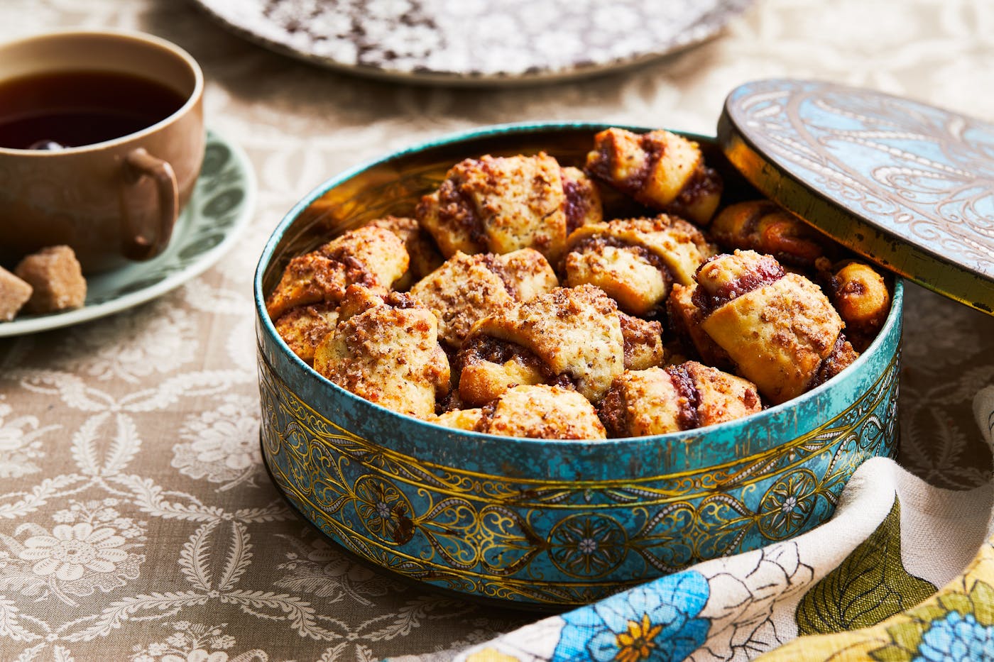 Jam-filled rugelach fill a gold-embossed cookie tin.