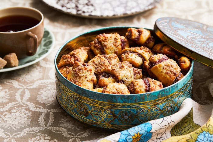 Jam-filled rugelach fill a gold-embossed cookie tin.
