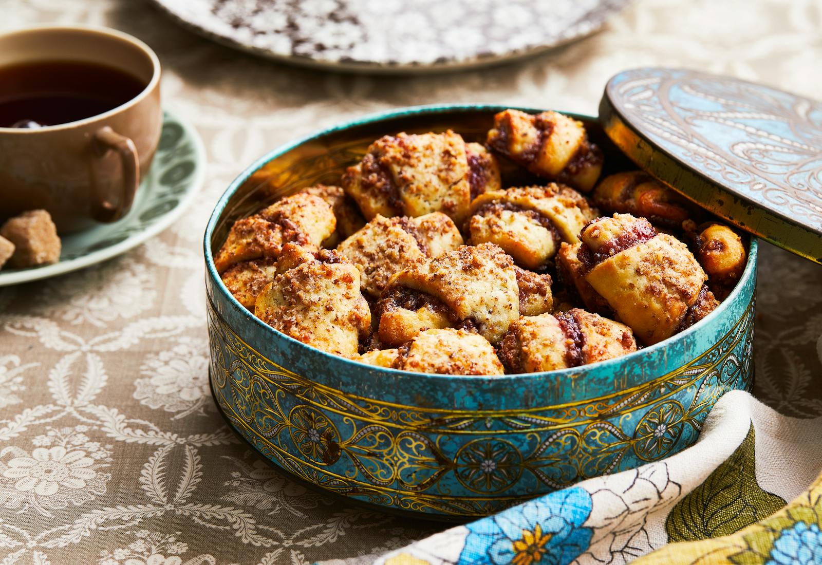 Jam-filled rugelach fill a gold-embossed cookie tin.