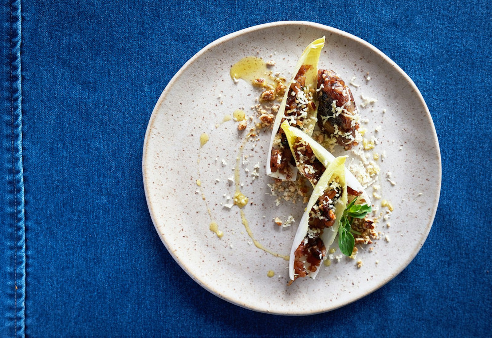 Apple and asian pear charoset in endive cups with sprinkle of white horseradish.