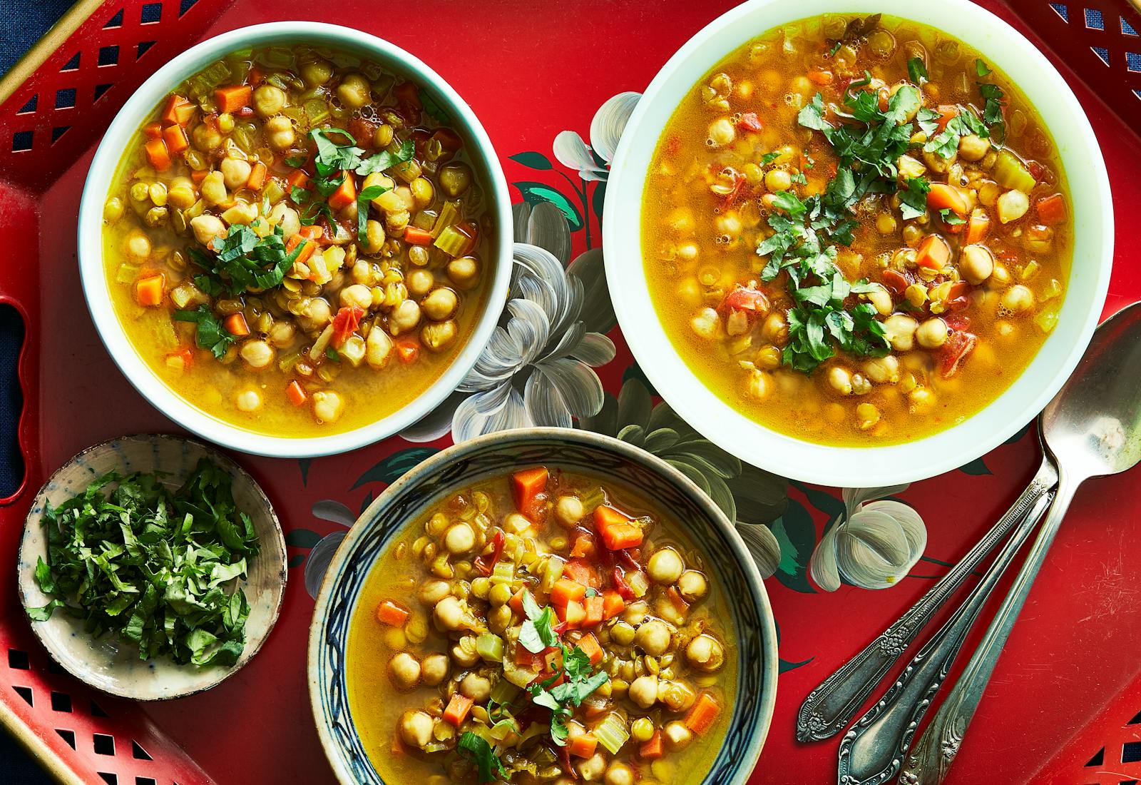 Moroccan harira soup garnished with fresh cilantro leaves.