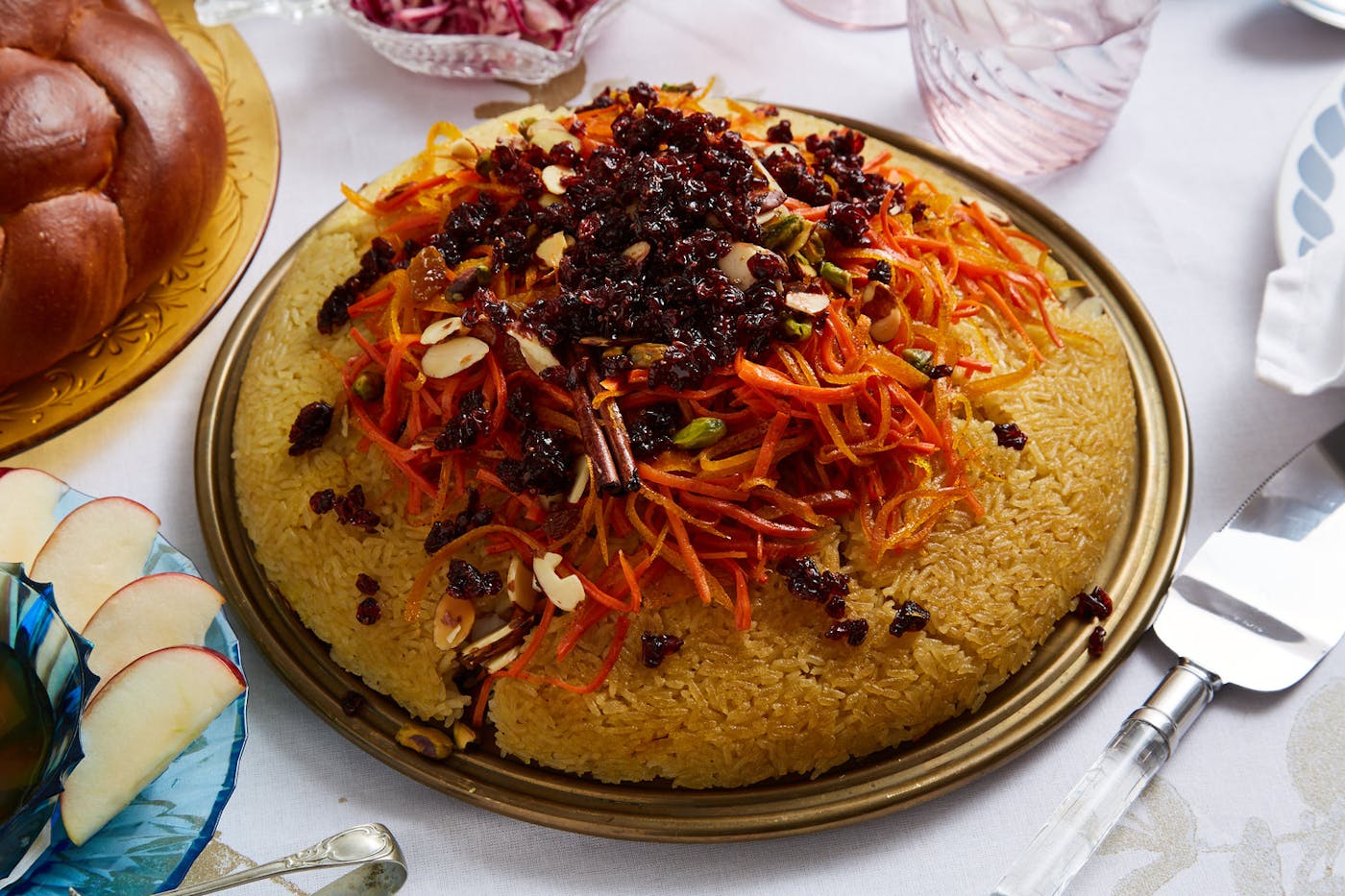 Crispy rice tahdig with caramelized fruit and nuts alongside challah, apples and honey.