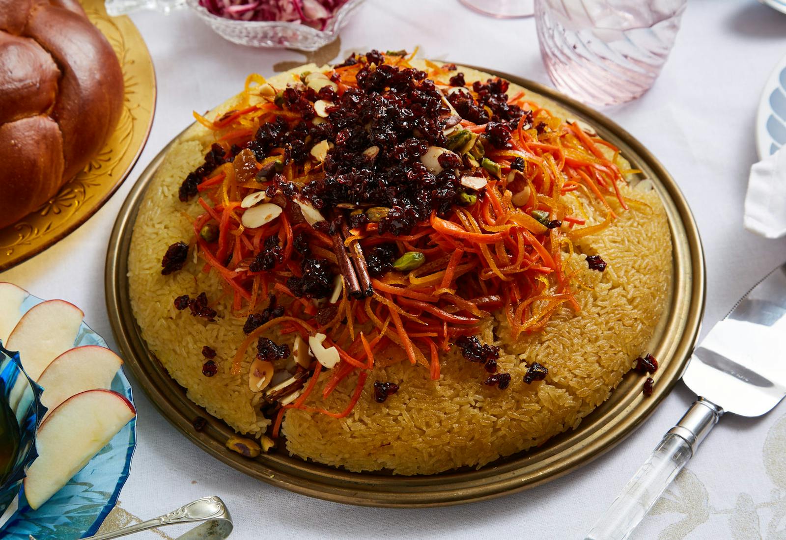Crispy rice tahdig with caramelized fruit and nuts alongside challah, apples and honey.