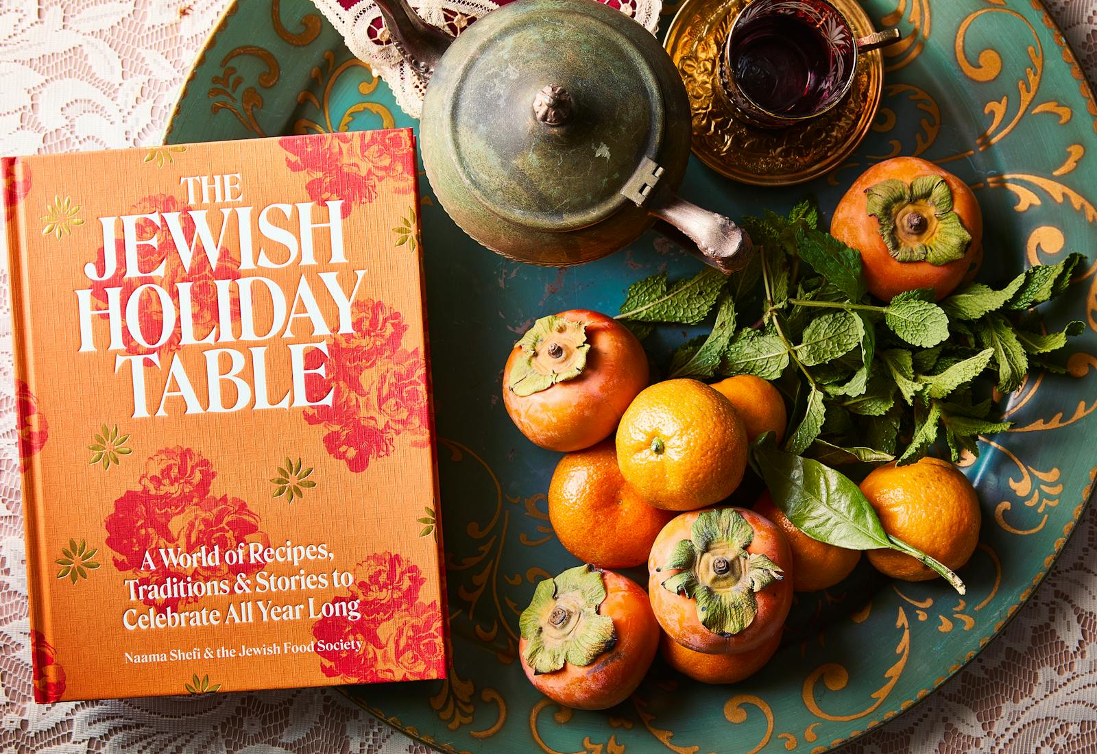 cookbook on tray with fruit and teapot