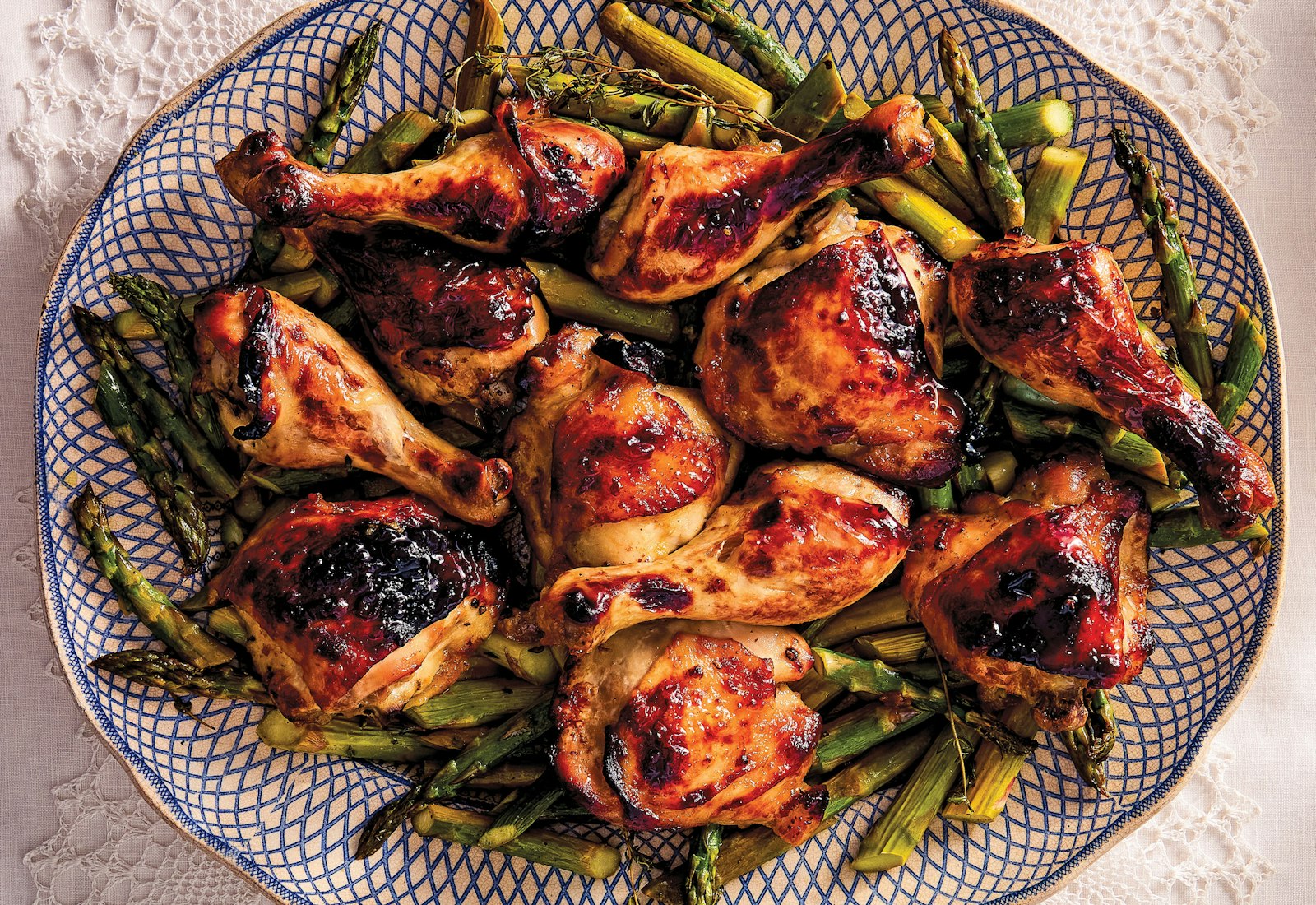 Roasted chicken and asparagus on a platter.