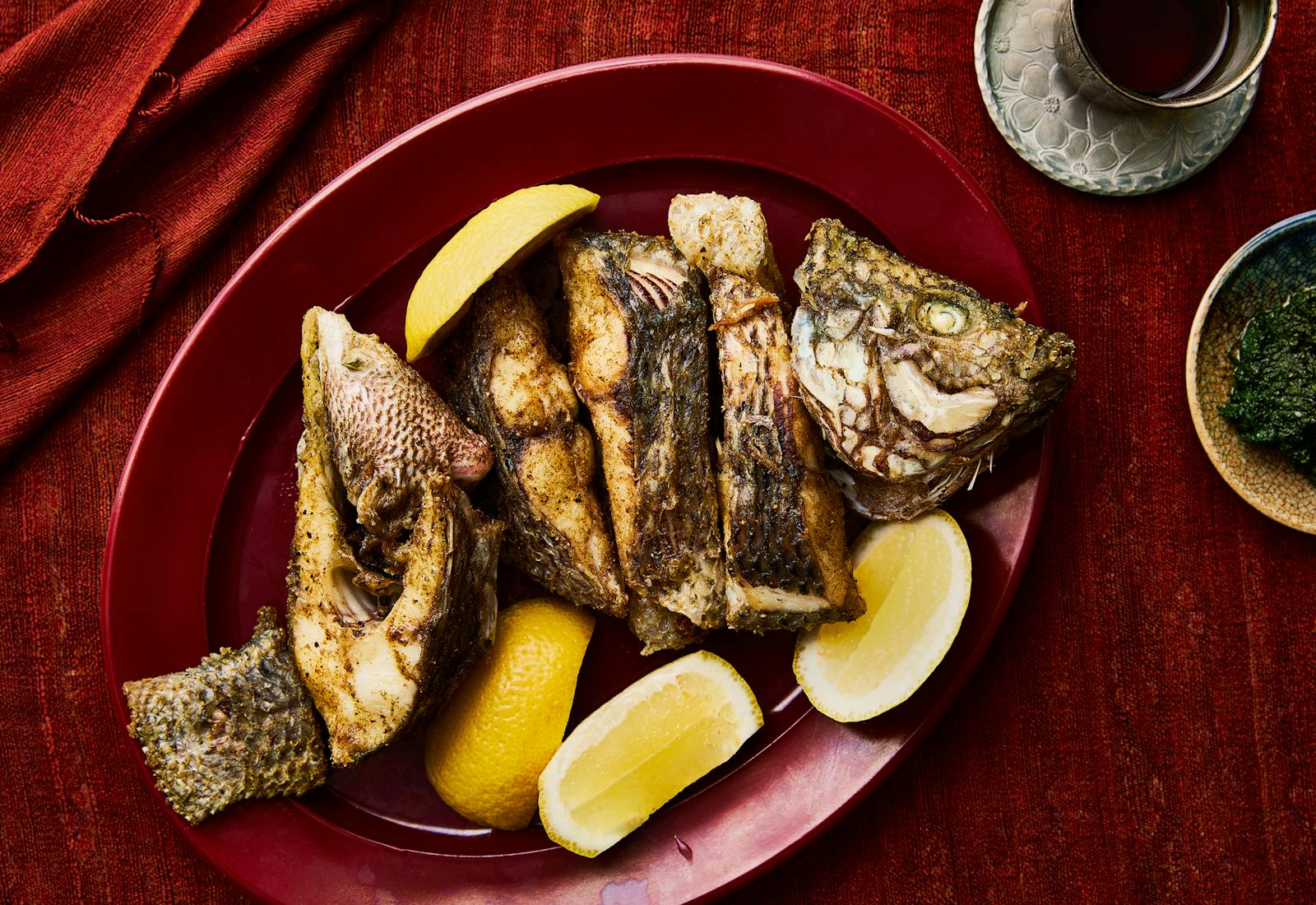 fried fish and lemon wedges on a plate