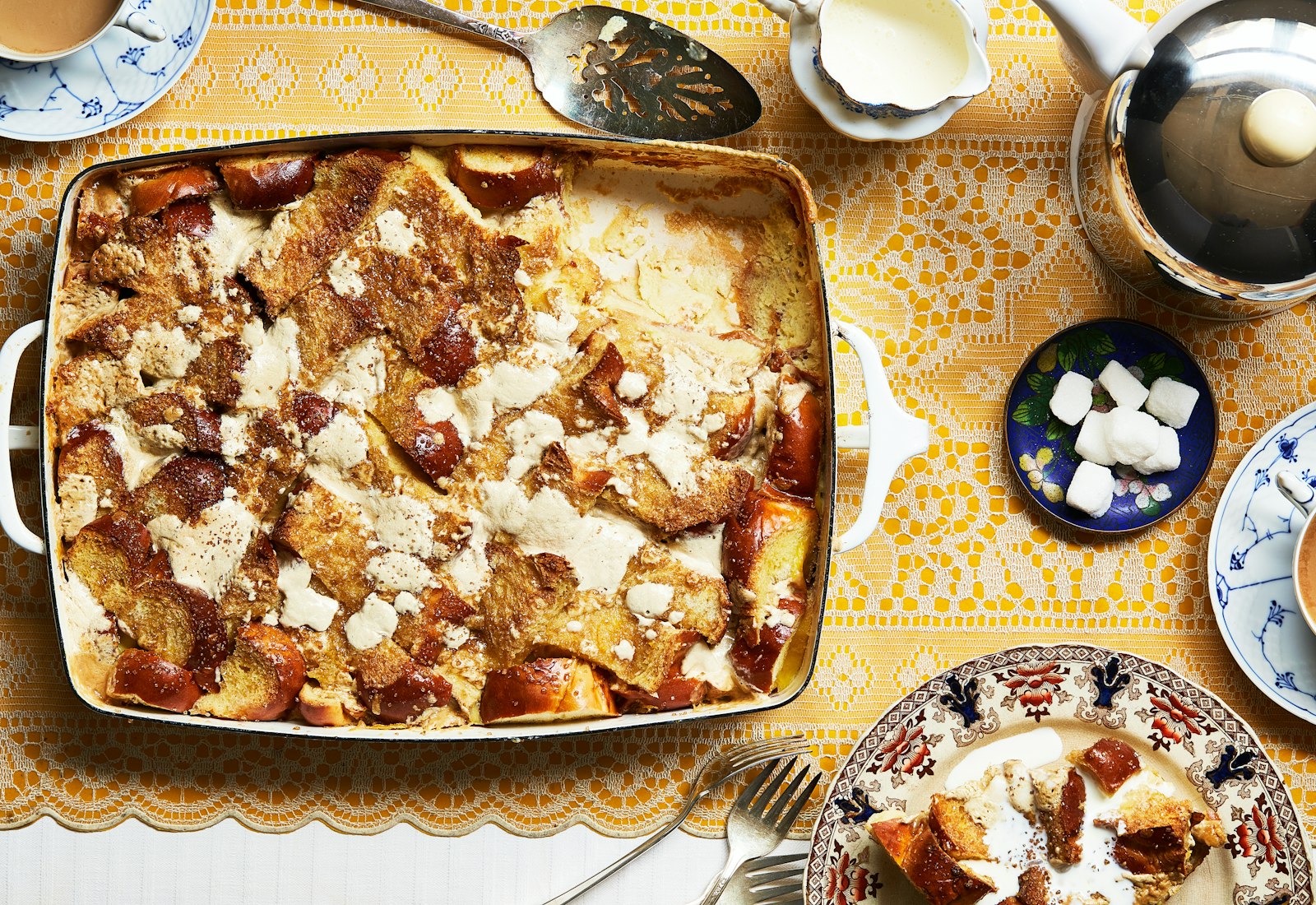Challah bread pudding with halvah alongside cold heavy cream and coffee.