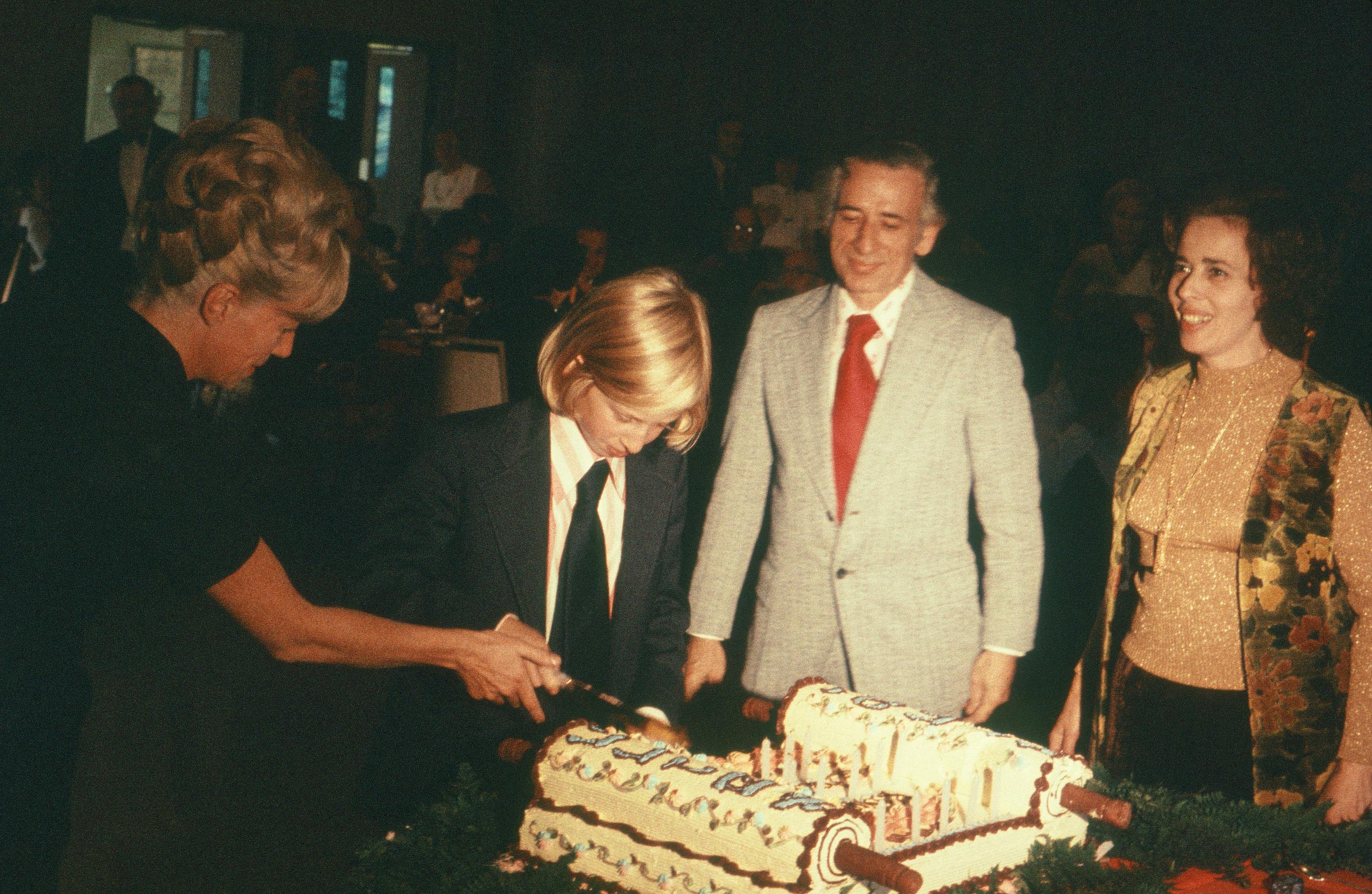 Kenneth Stern cuts Bar Mitzvah cake with parents Jack and Zosia.