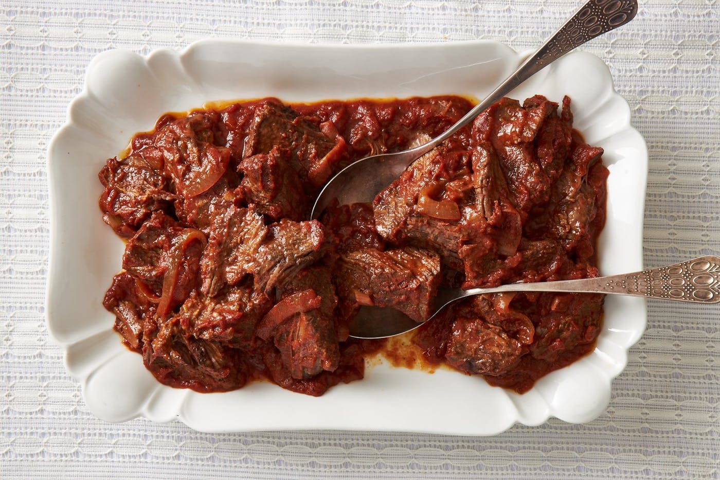 Beef stracotto, white serving plate.