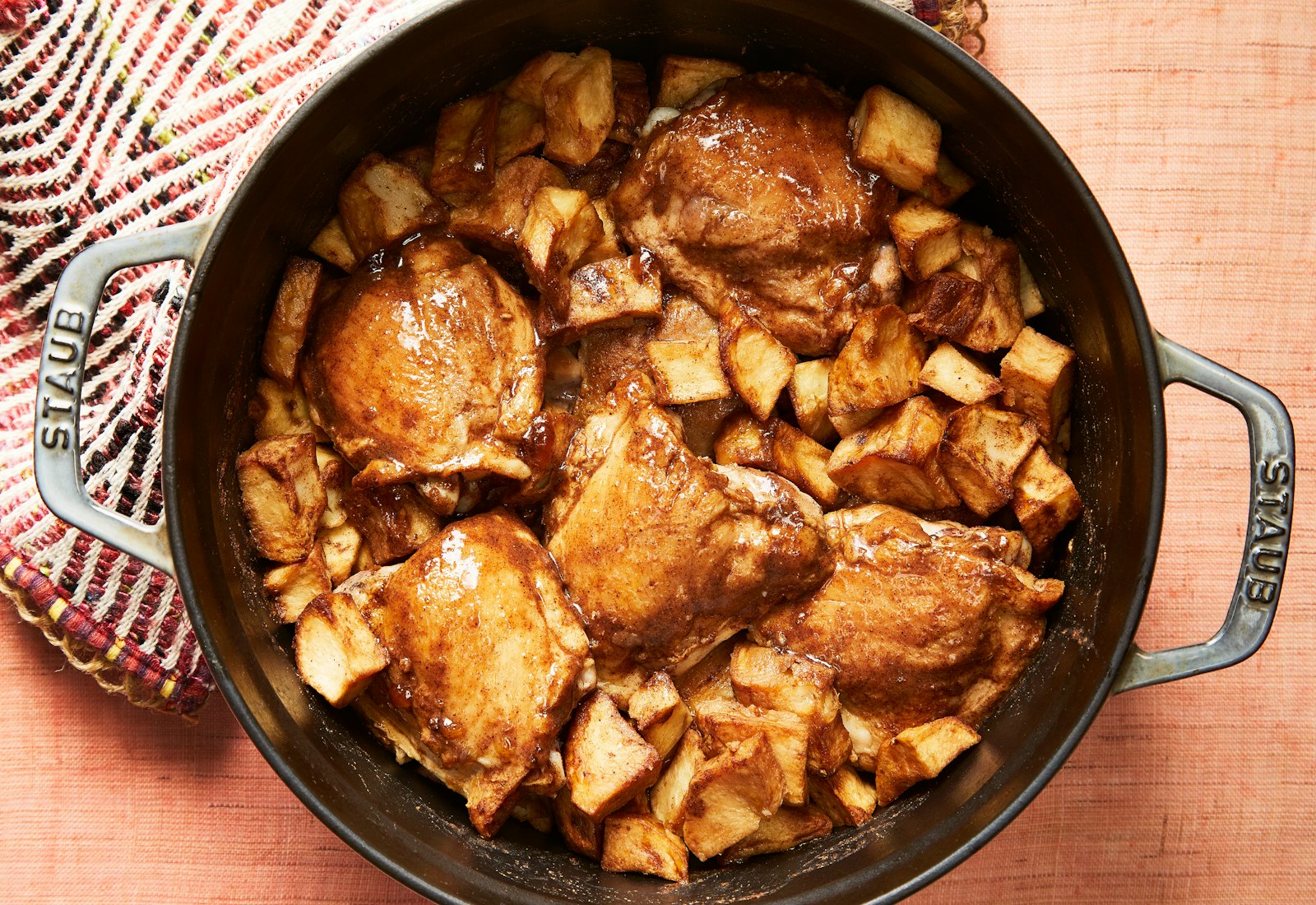 Maudeh in casserole dish atop salmon tablecloth.