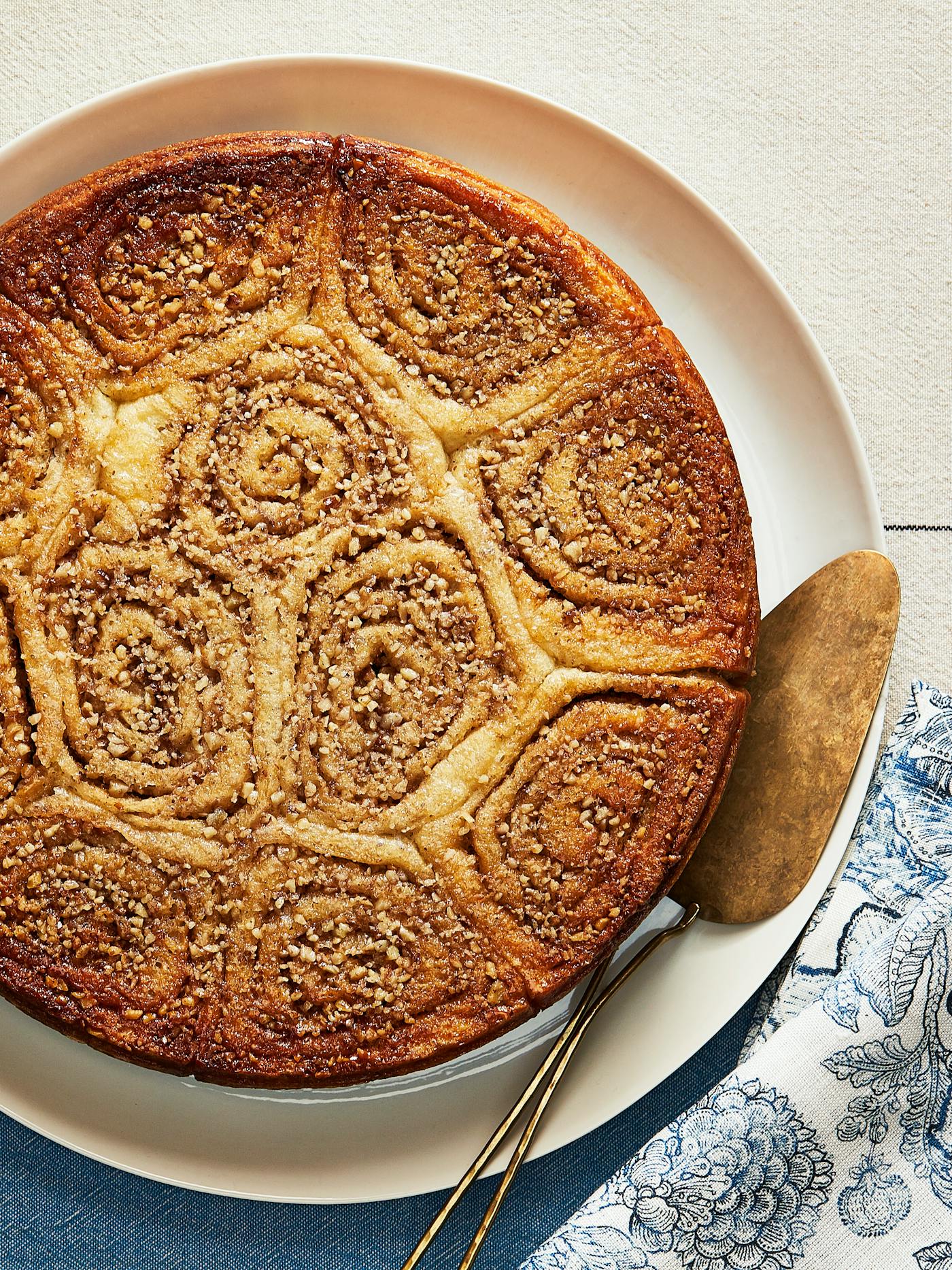 Wasp nest cake atop blue patterned tablecloth.