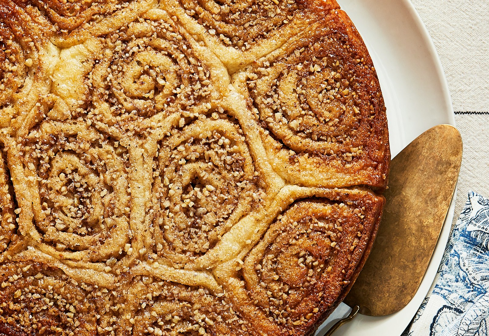Wasp nest cake atop blue patterned tablecloth.