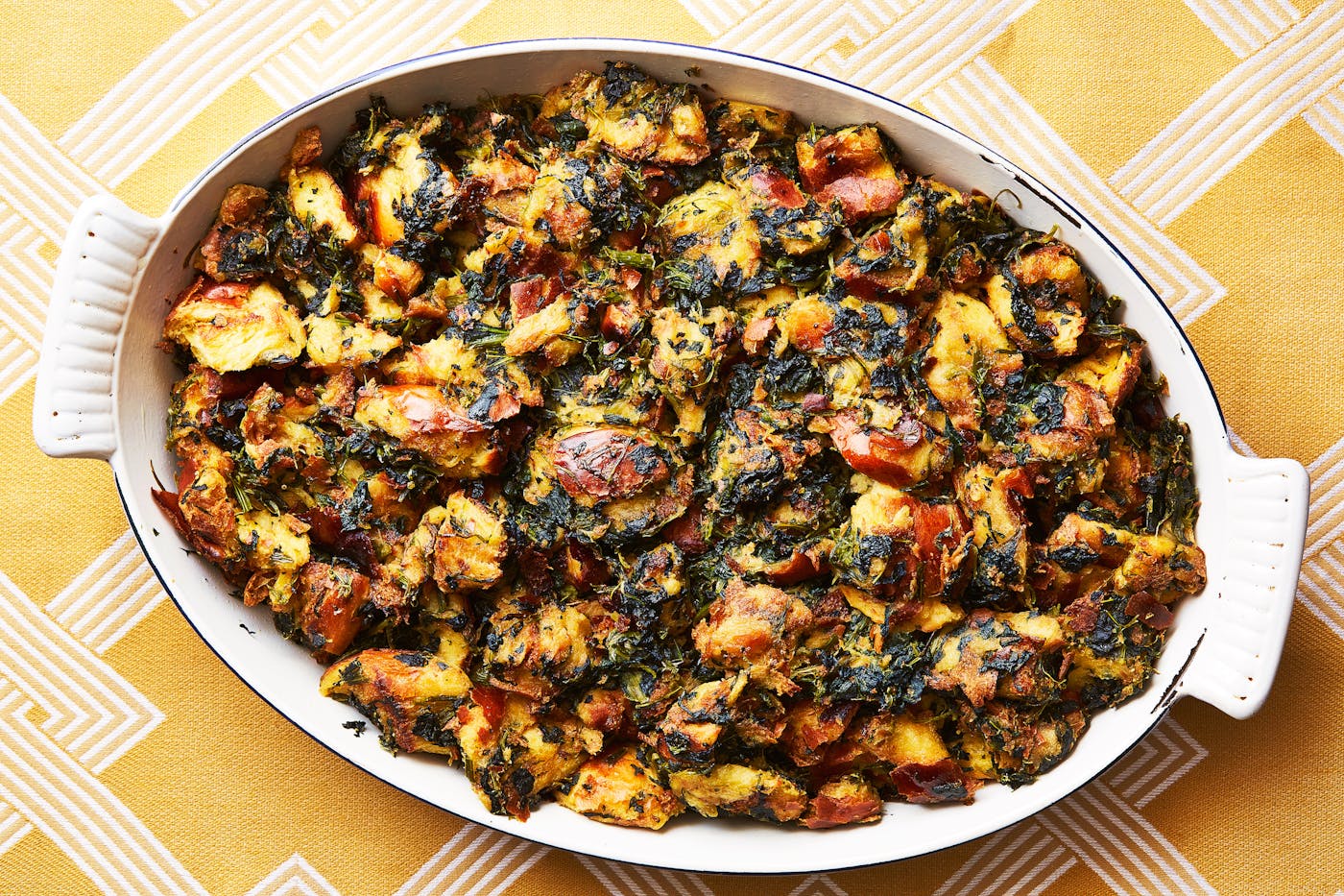 Spinach and challah stuffing in large serving dish.