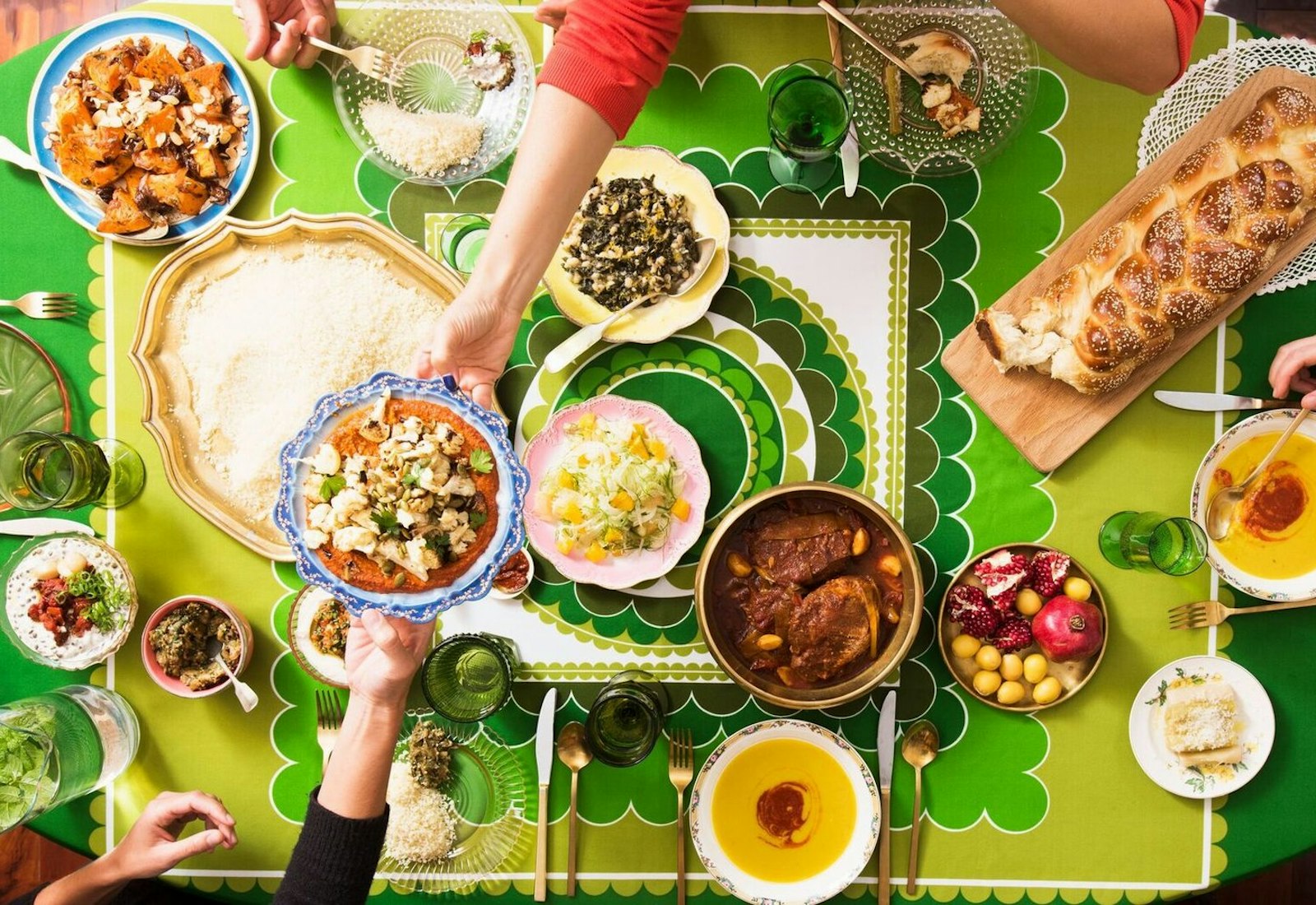 Sukkot dinner spread with fava bean soup, salads, and challah.