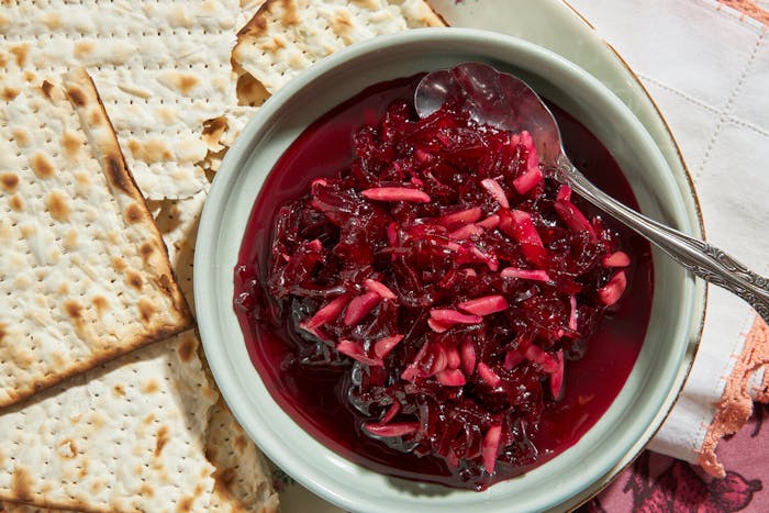 Eingemacht in small bowl with sheets of matzo atop pink and white napkin.