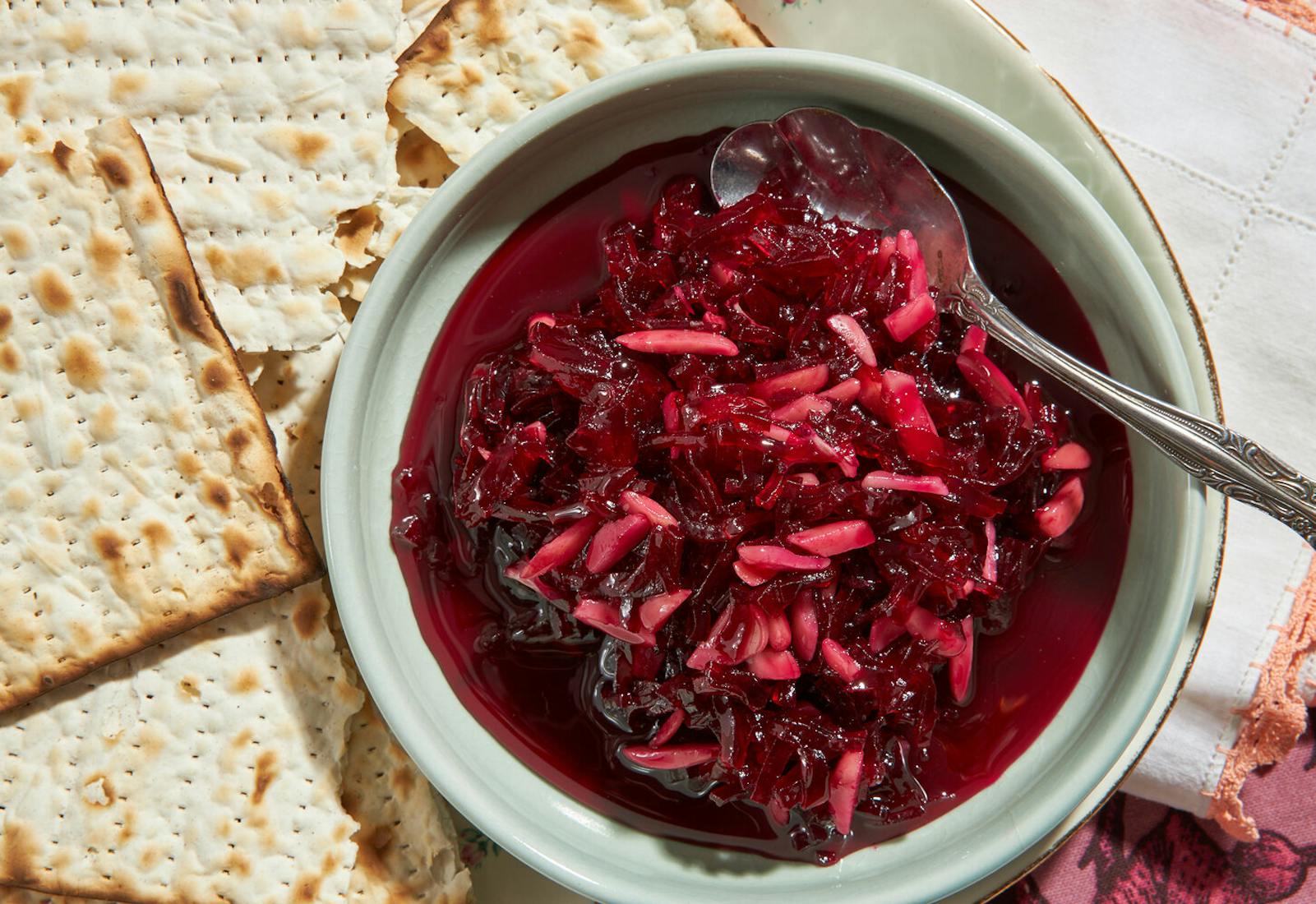 Eingemacht in small bowl with sheets of matzo atop pink and white napkin.