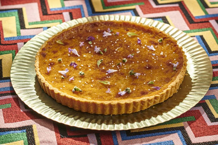 Ethiopian honey tart with edible flower garnish
