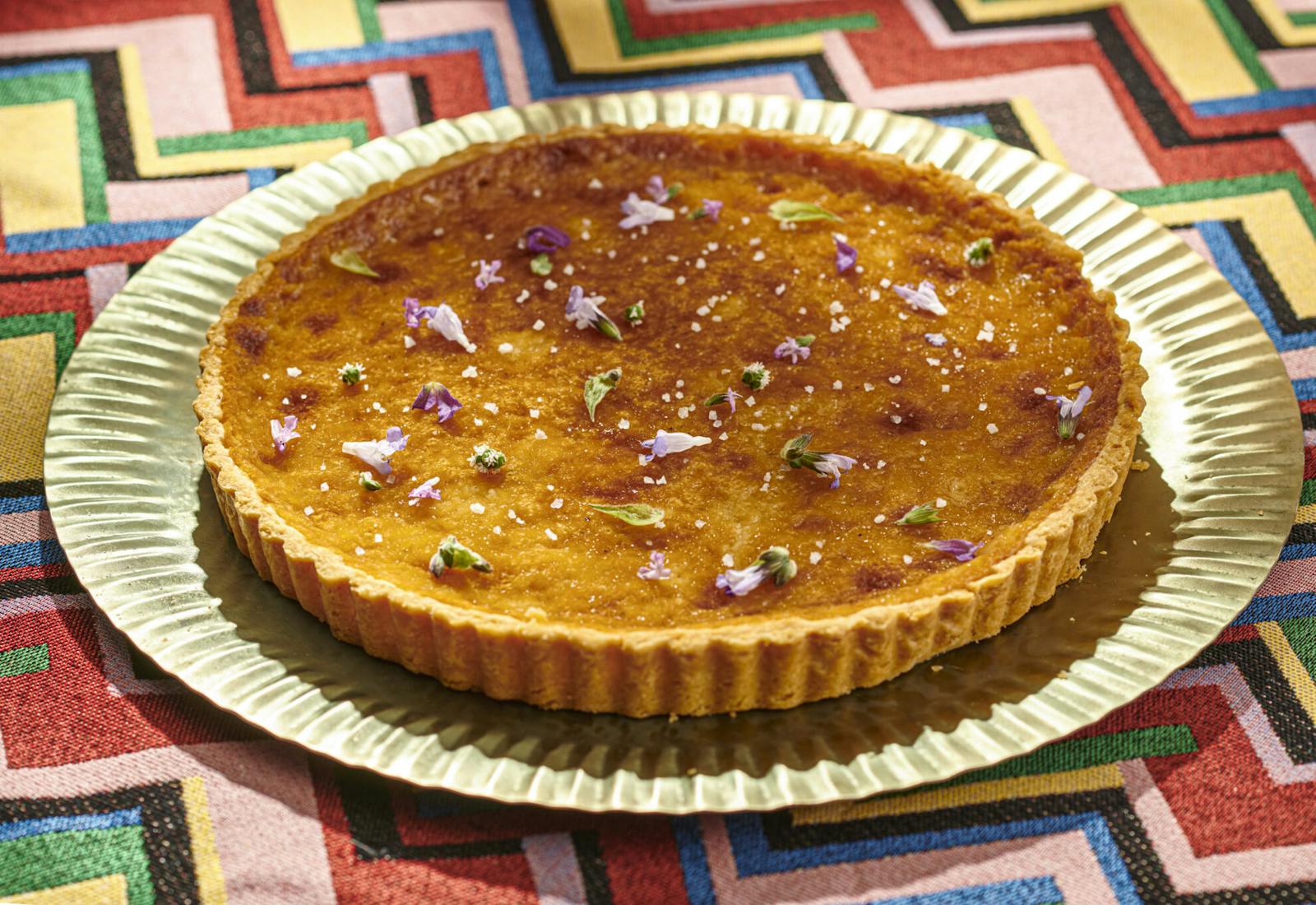 Ethiopian honey tart with edible flower garnish