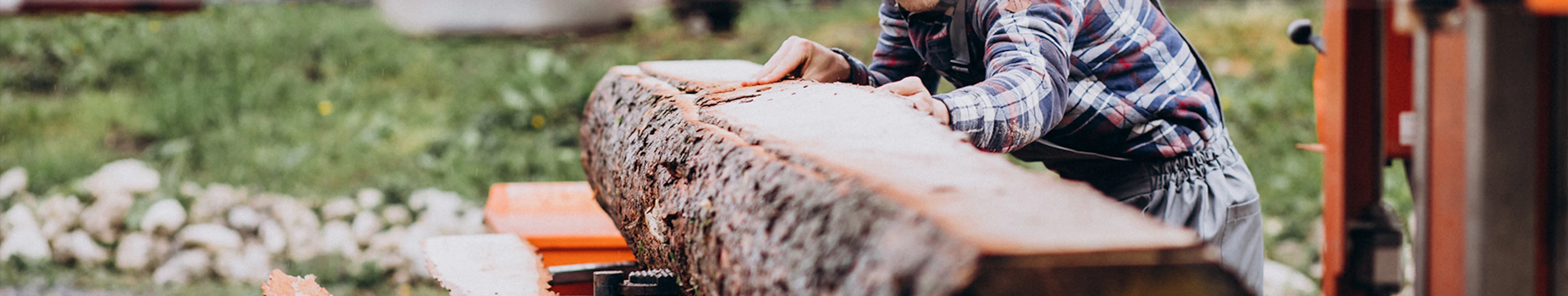 close up of sawmill worker cutting lumber