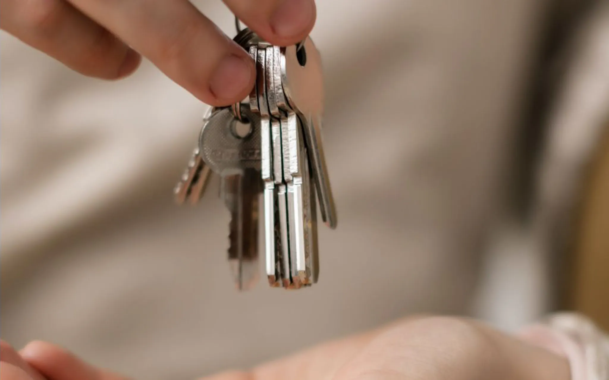 A person handing over a set of keys