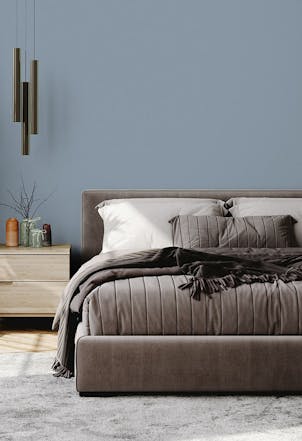 Bedroom painted with a mid-blue shade