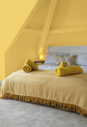 Bedroom painted with Spiced Butternut yellow