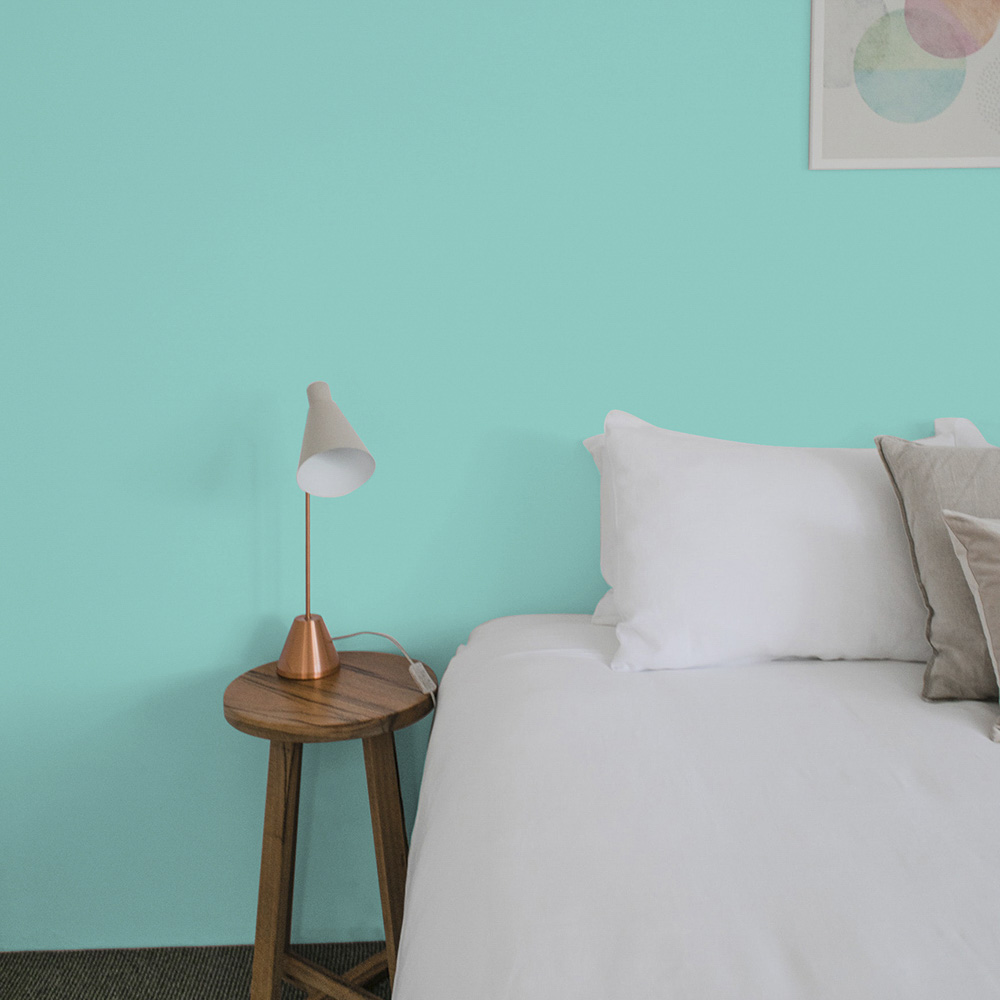 teal bedroom wall painted with Tropical Holiday