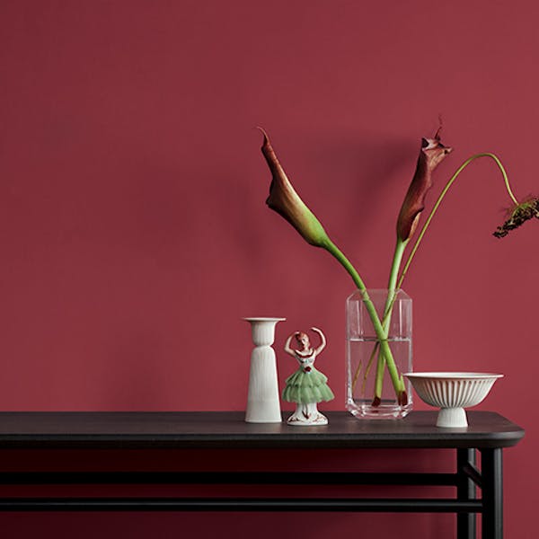 berry red wall with black table