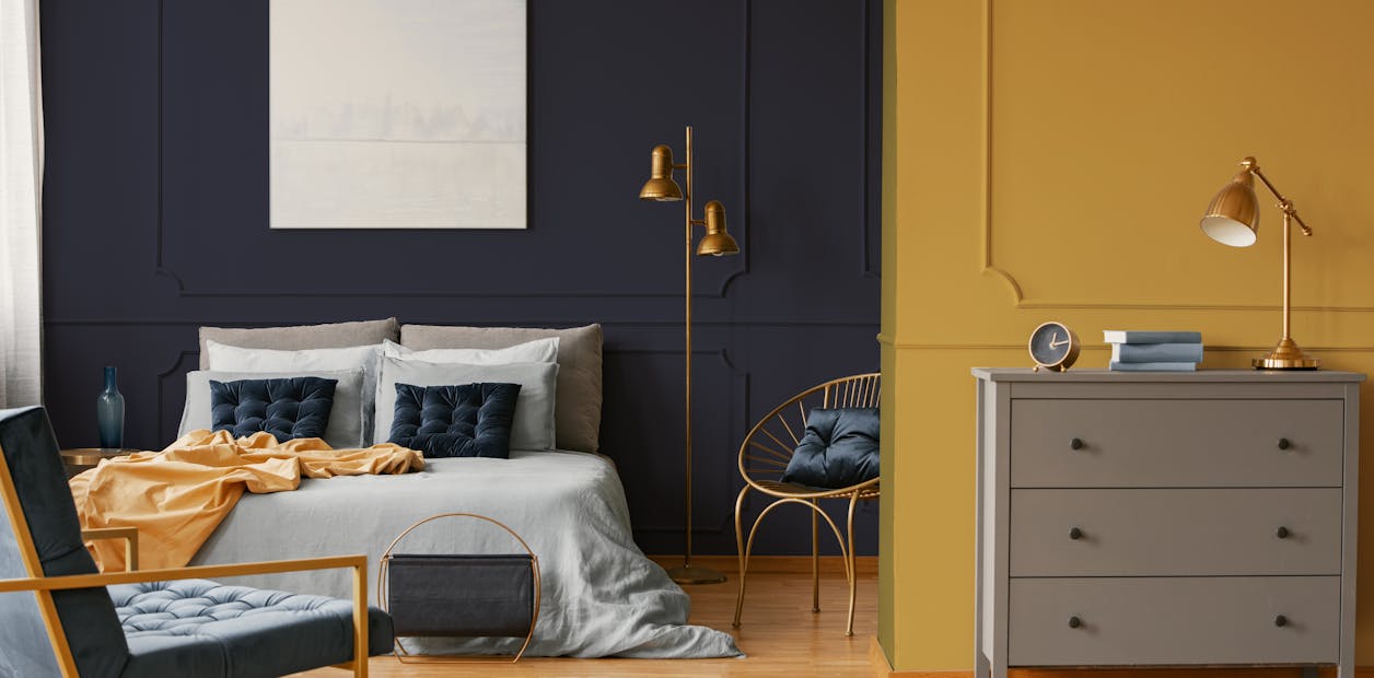 deep blue and muted mustard bedroom 