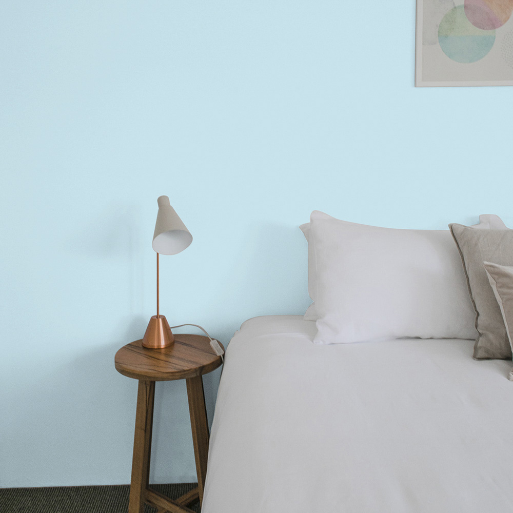 Bedroom painted in lighter blue paint