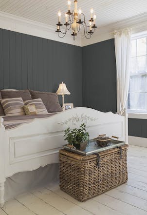 Bedroom painted with a dark grey hue