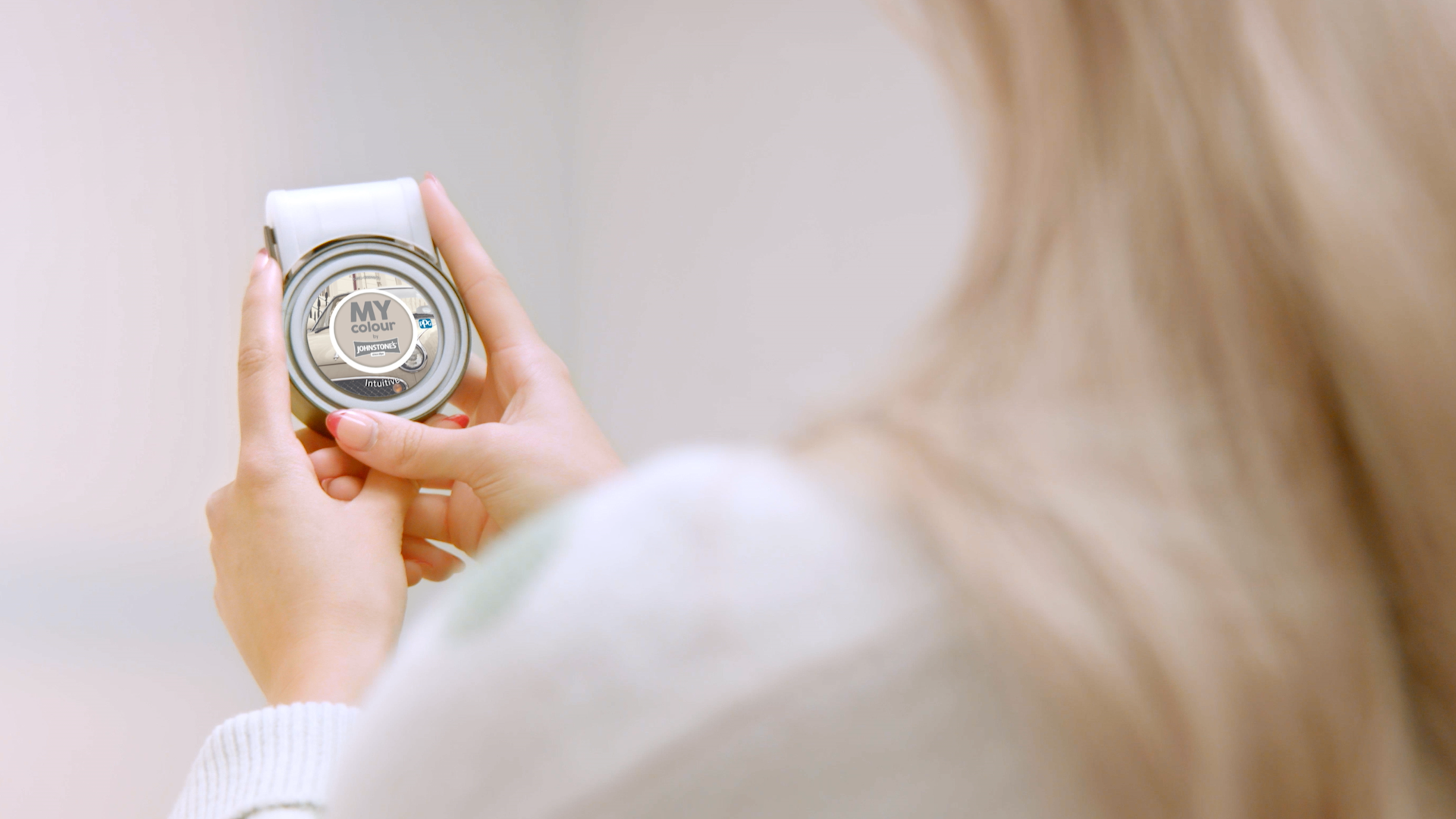 woman holding a Johnstones MY colour tester 