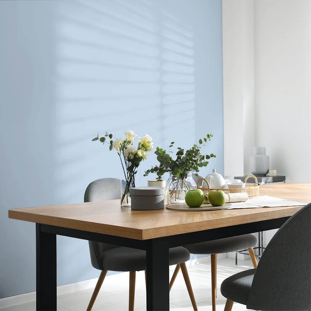Dining room with a pastel blue wall 