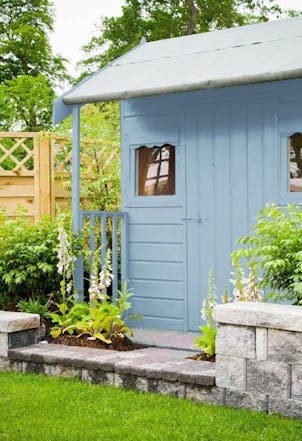 garden shed painted in a pastel blue shade