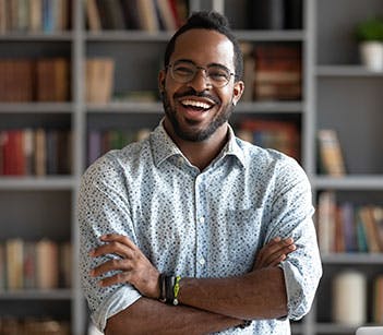 Man laughing with arms crossed