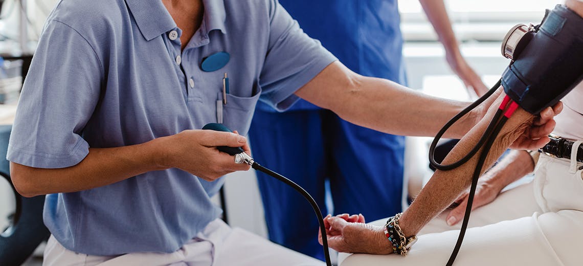 Image of a nurse taking a patient's blood pressure.